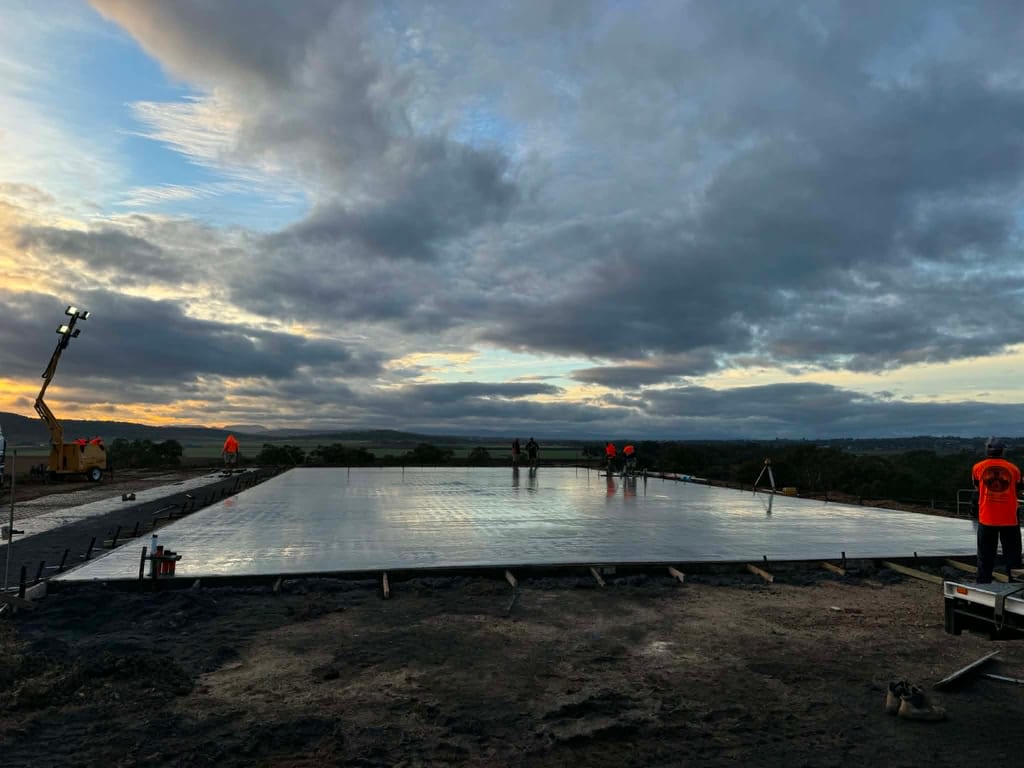 Large concrete slab poured at dusk by Mark Collins Builder